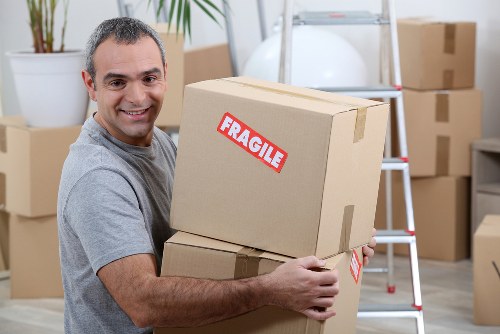 Moving truck loading household items for a Kingston property