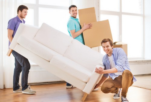 Staff securing furniture and boxes safely inside a moving van