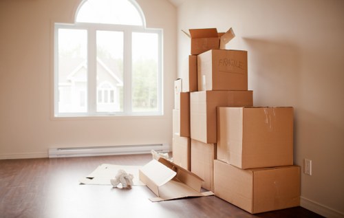 Professional movers carrying furniture through a Kingston home entrance