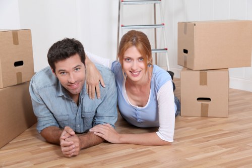 Professional movers carrying furniture through a Kingston property