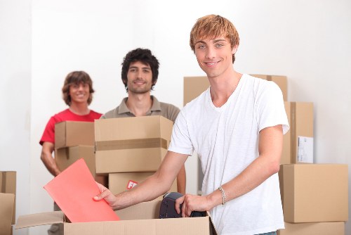 Packed moving boxes and furniture ready for a Kingston house move