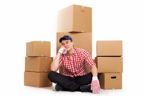 Local removals van loading household items from a Kingston property
